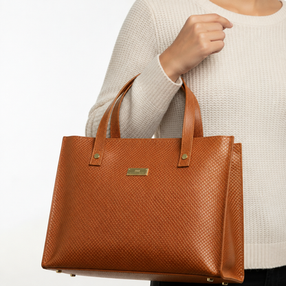 Model carrying the honey-colored Valeria Textured Leather Tote Bag